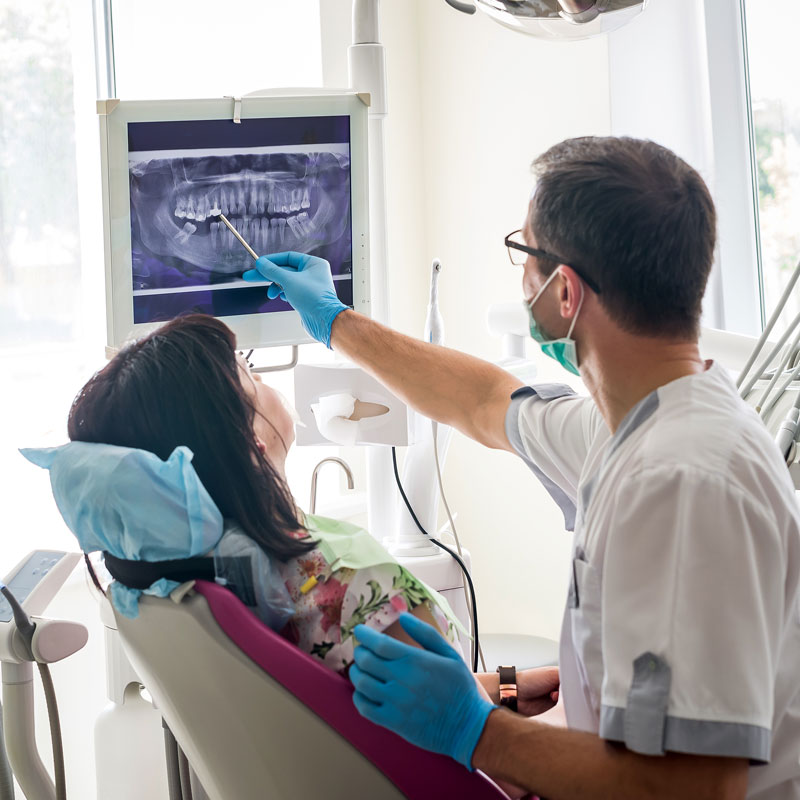 doctor showing patient a dental x-ray