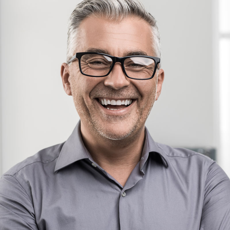 man with glasses smiling
